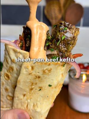 Persian Sheet Pan Beef Kefta Wraps 🔥 All the flavor, none of the fuss… juicy spiced beef, roasted garlic sauce, & a zesty salad  For ALL of you asking for the app: search “osta recipes” on the app or google play store 🫶 For the Beef Kefta: -1.5-2lbs lbs lean ground beef (700-900 g) -8 garlic cloves, minced -2 tsp smoked paprika, 2 tsp cumin, 1 tsp allspice, 2 tsp salt, 2 tsp black pepper, 1 tsp turmeric, 1 tsp cinnamon  -1/3 cup fresh parsley, chopped -1/3 cup fresh cilantro, chopped (optional) -1 large or 2 medium yellow onions, grated + squeezed dry* -On top before baking: 4 tbsp olive oil For the Roasted Garlic: -2 garlic heads, 1 tbsp olive oil and 1 tsp salt For the Fresh Salad: -1/2 large red onion, thinly sliced -1 cup cherry tomatoes, quartered -1/4 cup fresh parsley, chopped -1 tsp salt, 1 tsp pepper & 2 tsp sumac -Juice of 1/2 lemon Roasted Garlic Paprika Sauce: -Roasted garlic cloves, 1/2 cup Greek yogurt, juice of 1/2 lemon, 3 tbsp tahini, 2 heads of roasted garlic, 2 tbsp ice water, 1 tsp each: paprika, cumin, salt, pepper. Optionally add fresh chopped parlsey/cilantro. 1. Preheat oven to 400°F (205°C). Slice the tops off two garlic heads, drizzle with olive oil and salt, wrap in foil, & roast for 45–60 mins until golden and soft. While the garlic roasts, prep the kefta. 2. Grate the onion, squeeze out all liquid with paper towel or cheesecloth (prevents watery kefta.) In a large bowl, combine beef, garlic, spices, parsley, cilantro (if using), and the grated onion. Mix with your hands for 2–3 minutes until sticky & well combined. 3. Spread onto the sheet pan in a 1/2-inch (1.25 cm) thick rectangle. With a knife, score into 1-inch strips (2.5 cm). Drizzle evenly with 4 tbsp olive oil. Bake for 12–15 minutes at 400°F, then broil 2–5 minutes until golden & crisp on top. Careful removing! 4. Toss onion, tomatoes, parsley, salt, pepper, sumac, & lemon juice in a bowl. 5. Squeeze roasted garlic cloves into a bowl, mash, mix with yogurt, lemon juice, tahini, water & spices. On lavash/pita: add sauce, kefta, & salad. Roll tight. Crisp the wrap in a lightly oiled skillet. #Recipe #dinner #persian #cookingathometiktoktv #easydinner #DinnerIdeas 