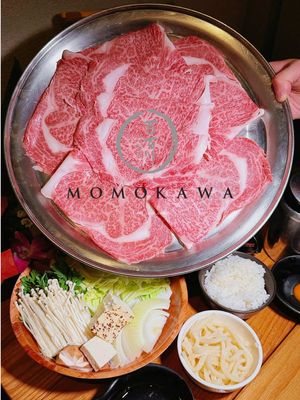✨ MOMOKAWA NYC: Where Winter Dreams Meet Miyazaki Magic✨🍜 📍Momokawa 📍1466 East 1st Avenue New York, NY 10075 Tucked away on the Upper East Side, Momokawa isn't just a restaurant—it's an emotional journey that brings you back to forgotten pleasures and transports you somewhere entirely new 🗽❄️ This Japanese family gem gets PACKED every winter (we're talking lines out the door! 👥) because they're one of the only handful of places in NYC authorized to serve authentic MIYAZAKI BEEF🥩👑 Let's talk about what makes this place absolutely unforgettable: We started with their ASSORTED SASHIMI featuring 7 kinds of fish 🐟 The high-end fish melted on our tongues, fresh UNI💋 Creamy, ocean-sweet perfection! Their Tori Kara-Age delivered that satisfying crunch outside while staying impossibly juicy inside—local farm chicken marinated in soy that hits different 🍗🔥 But here's where simple becomes extraordinary: the Dashimaki Tamago 🍳💛 This isn't just an omelet—it's a warm hug from Japanese street food culture! The STAR of the show: MIYAZAKI BEEF SUKIYAKI🌟🥩🌟 Listen up: many NYC spots *claim* Wagyu, but that incredible marbling you see here? That's REAL Miyazaki—the KING of Wagyu 👑 Once you witness that beautiful fat distribution and taste that buttery, umami-rich beef in premium sukiyaki sauce with fresh vegetables, you'll NEVER mistake it for anything else. It's warm, it's hearty, it's unforgettable 💕 This dish is why we return EVERY. SINGLE. WINTER. No exceptions 🔄❄️ The way it comforts you through cold New York nights, creating memories that last until next season... that's the magic 🪄 📍 Momokawa NYC—where meticulous chefs deliver earth's finest products with care that feels like home 🏠💫 #MomokawaNYC #MiyazakiBeef #BestSukiyaki #UpperEastSide #NYCEats    🍶