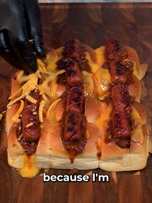 We all know Chili Cheese hot dogs are top tier, but will it slider? Chili Cheese Dog Sliders using @KING’S HAWAIIAN Original Sweet Rolls. INGREDIENTS 1 pack King's Hawaiian Original Sweet Rolls 2 cups grated sharp cheddar cheese 1/4 cup melted garlic  butter 1/2 pound ground beef 1 cup small diced onion 2 cloves minced garlic 2 tbsp chili powder 1 tbsp cumin 1/4 cup tomato paste 1 tbsp cocoa powder  2 cup beef stock 1/2 cup hot sauce Salt and pepper to taste 12 mini beef smokies 1/2 cup small diced onions 1/4 cup chopped chives  1/2 cup grated cheddar cheese