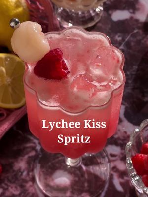 Cupid called he wants his Lychee Kiss Spritz back 💕 6 raspberries  2 lychees  .5 oz fresh lemon juice  .25 oz simple syrup  1.5 oz lychee syrup (from the canned lychees) 1.5 oz gin  2-3 oz prosecco  Raspberry and lychee for garnish  In a cocktail shaker, combine raspberries, lychees, lemon juice, and simple syrup. Muddle to release the fruit’s juice. Add lychee syrup and gin, then shake with ice. Strain into a glass filled with ice and top with prosecco. Garnish with a raspberry and lychee. #cocktailrecipes #ValentinesDay #valentinescocktails #valentinesdrinks #galentines   