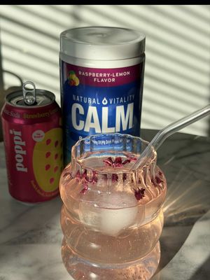 A light, fruity CALMtail made for soft sips and feel good moments. Say hello to Pink Berry Pop 💗🍓✨   ✨ How we make it: • 2 tsp CALM (raspberry lemon) • 4 oz Poppi Strawberry Lemon • Sparkling water to top • Garnish: pink edible glitter + rose petals   Bright, bubbly, and calming.* A little pop of pink to sweeten your day. 💕😌   *This statement has not been evaluated by the Food and Drug Administration. This product is not intended to diagnose, treat, cure, or prevent any disease.   #calmtails #naturalvitality #mocktails #relax