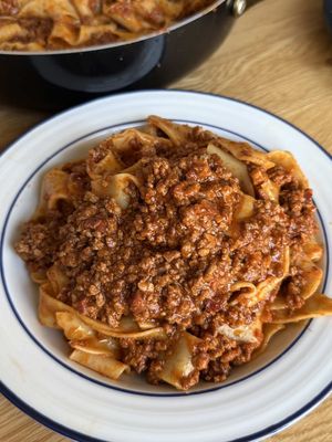 Ragù alla Bolognese is a traditional Italian meat sauce cooked low and slow. Built with simple ingredients and patience, this is classic Italian comfort food. A recipe that brings a little taste of Bologna to your table. 🇮🇹 What pasta would you serve this with? Ingredients: 6 oz pancetta, cubed 1 knob of butter 1 medium onion, finely diced 2 carrots, finely diced 2 celery stalks, finely diced 1 lb ground beef 1 lb ground pork 1 cup dry white wine 2 tbsp tomato paste 2 cups tomato passata 2 cups vegetable stock 2 bay leaves Salt & black pepper Pinch of nutmeg 1 cup whole milk, warm Parppardelle pasta Instructions: 1. Render pancetta over low heat (no oil needed). 2. Add butter and soffritto (onion, carrot, celery). Cook for 10 minutes until soft. 3. Add beef and pork. Brown the meat well, seasoning with salt and pepper. 4. Deglaze with white wine. Let it fully evaporate. 5. Stir in tomato paste. Cook for 2 minutes to deepen flavor. 6. Add tomato passata, vegetable stock, bay leaves, and nutmeg. Stir well. 7. Simmer on very low heat for 2 hours, stirring occasionally. 8. Stir in warm milk. Cook for another 30 minutes until silky. 9. Cook pasta until al dente and toss it right into the sauce.  #pasta #italianfood #fyp 