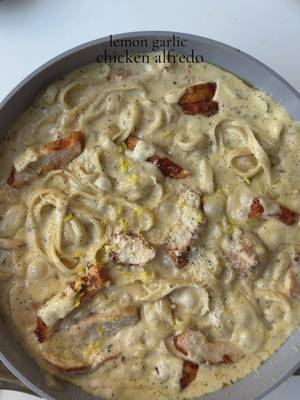 Lemon garlic chicken Alfredo 🍋🧄 Ingredients  For the chicken: 1 chicken breast, halved lengthwise into even thickness  Salt to taste 1 tsp smoked paprika powder  1 tsp garlic powder  1/2 tsp black pepper powder  1 tbsp oil ( for marinating )  2 tbsp oil for cooking  For the sauce: 1 1/2 tbsp all purpose flour  5 tbsp butter  1 1/2 cup unsweetened heavy whipping cream, room temp Salt to taste 1/2 tsp black pepper  1 tsp garlic powder  1 tsp Italian seasoning  1 tsp dried parsley  3/4 cup freshly grated Parmesan cheese  1 tbsp lemon zest 2 tsp lemon juice  To assemble: 9 oz fettuccine  1 cup pasta water Method:  Pat the chicken dry and season it with salt, pepper, garlic powder, and smoked paprika powder. Add oil and mix well to combine. Let it marinate for 30 minutes. Bring a large pot of generously salted water to a boil. Cook fettuccine until al dente. Reserve 1 cup pasta water, then drain. In a pan add oil add the marinated chicken and cook for 4–5 minutes per side on medium-high heat, depending on thickness. Remove the chicken in the same pan add butter once the butter is melted. Add the all purpose, flour.  Whisk constantly for 30-40 sec to cook out the raw taste (do not brown). Add in heavy whipping cream. Mix and add salt, garlic powder, black pepper, Italian seasoning, dried parsley. Simmer gently for 3–4 minutes, stirring, until slightly thickened. Reduce heat to low, then stir in Parmesan cheese until melted and smooth. Add lemon zest and lemon juice. Taste and adjust salt or lemon if needed. Add cooked fettuccine to the sauce. Add ¼ cup at a time, as needed . Toss gently, adding reserved pasta water a little at a time until the sauce is silky and coats the pasta beautifully. Add sliced chicken and toss again. Simmer on low for 1–2 minutes to let everything come together. Garnish with extra Parmesan, parsley, or a pinch of black pepper. Optional: a tiny drizzle of olive oil or butter on top for extra gloss  #Recipe #chickenalfredo #lemongarlic #pasta 