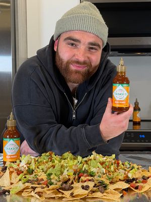 Loaded Tabletop Nachos w/ @tabascobrand Salsa Picante - Ultimate Game Day Appetizer. Whether you’re yelling at the TV or guarding the nacho table ,TABASCO® Salsa Picante brings the heat. Recipe Details: Prep Time: 15 minutes Cook Time: 15 minutes Total Time: 30 minutes Servings: 4 people Difficulty: Easy Spicy Level: Medium Nutrition (whole dish) Calories: ~4,000 kcal Protein: ~160 g Carbohydrates: ~280 g Fat: ~230 g Nutrition (per serving, approximate) Calories: ~1,000 kcal Protein: ~40 g Carbohydrates: ~70 g Fat: ~58 g Ingredients: 1 lb ground beef 1 teaspoon salt ½ teaspoon black pepper 1 teaspoon ground cumin 1 teaspoon chili powder ½ teaspoon paprika 1 (15 oz) can black beans, drained and rinsed 1 large bag tortilla chips Cheese Sauce ½ cup milk or heavy cream 2 cups shredded cheese (cheddar, Monterey Jack, or blend) TABASCO® Salsa Picante to taste Toppings: 1 cup pico de gallo ½ cup sour cream 1 cup shredded lettuce ½ cup guacamole ¼ cup fresh cilantro, chopped Finish: TABASCO® Salsa Picante, to taste Instructions: Season and cook ground beef in a pan on medium-high heat until cooked through and browned. Heat black beans in a pot until warm. Prepare the cheese sauce in a pot over medium heat. Add milk to pot. Once warm, slowly add cheese and continually stir until melted and blended. Once melted, add TABASCO® Salsa Picante to spice level preference. Stir until combined. Next, cover countertop or tabletop in tin foil and assemble a layer of tortilla chips. Layer ingredients in the following order: ground beef, pico de gallo, cheese sauce, cilantro, shredded lettuce, sour cream, and guacamole. Finish with TABASCO® Salsa Picante to taste. Contains: Dairy (milk, cheese, sour cream) Does NOT contain: Gluten Alcohol Nuts (peanuts or tree nuts) Suitable for: Gluten-free diets (when prepared with certified gluten-free corn tortilla chips) Nut-free diets Not suitable for: Vegetarian diets Vegan diets Dairy-free diets