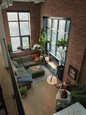 unwinding •  mid-century modern | toronto interior | brick loft living | warm light | lived-in spaces | hard loft | tall ceilings | large windows | natural light | vintage furniture | statement lighting | plants | architectural details | open living | modern apartment | home atmosphere | interior styling | design focused | quiet spaces • • #interiordesign #apartmentdecor #homedecor #homeinspo #homebody 