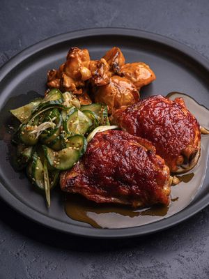 Gochujang chicken thighs with pickled cucumber and gochujang crispy potato salad. Find the full recipe on eatlikeanadult.com (clickable link in bio)