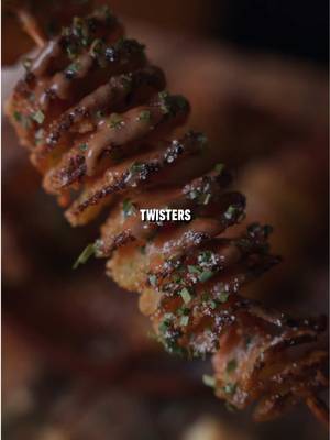 Grilled Potato Twisters 🥔 Recipe: -Skewer Yukon gold potatoes, cut them spirally around the stick, and open it up to space it out.  -Combine 1 cup Panko Breadcrumbs, 1/2 cup Parmesan Cheese, 1 tbsp Dried Parsley, 1 tsp Garlic Powder, and 3/4 tsp Cayenne Pepper in a bowl to make the crispy topping. -Paint the potatoes in melted butter and cover them in crispy mixture.  -Place them on a tray to elevate them and grill them indirect at 400F for 30-40 minutes or until crispy.  -Top with dipping sauce or sour cream, chives, and more Parmesan cheese.