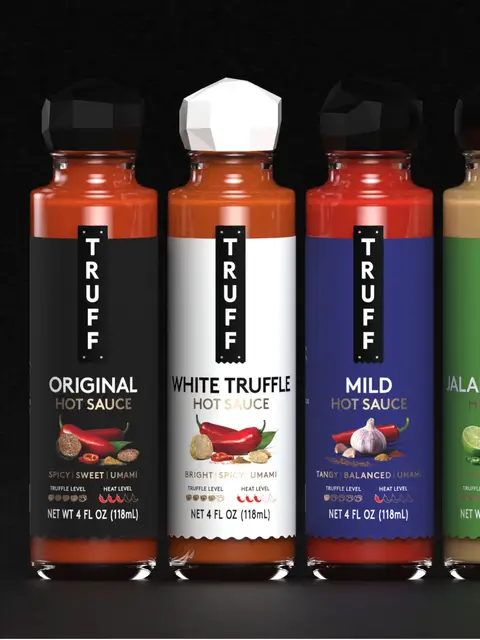 After 8+ years of our original design, today we unveil a new look for TRUFF — a more expressive front panel that puts our flavor story front and center. Now featuring ingredient imagery, descriptive flavor notes and truffle and heat meters, to show what’s inside before it ever hits the plate. Our all-black, iconic truffle-shaped caps signify the inclusion of rare black truffle, while our white truffle caps signify the inclusion of the ultra luxe white truffle.  Same obsession, sharper expression. TRUFF is the ultimate culinary flex that makes every meal craveable. Rolling out nationwide over the coming months.