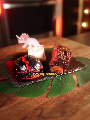 How many Dinosaurs did you count?🦕🌋   Not only did this meal look awesome but it tasted incredible as well. The sweetness of the bun and butter paired great with the richness of the meat. 👇 Full recipe: 🌋 LAVA BUNS INGREDIENTS: 🔸1.5 cups warm milk 🔸1 Tbsp melted butter 🔸2 Tbsp sugar 🔸1 Tsp salt 🔸2 Tsp instant dry yeast 🔸Red gel food coloring as needed 🔸3 cups all-purpose flour  🪨 TOPPING: ▪️1 1/4 cup rice flour ▪️1 Tsp instant dry yeast ▪️1 Tbsp sugar ▪️1 Tbsp vegetable oil ▪️3/4 cup warm water ▪️Black gel food coloring as needed ▪️1/2 tsp coarse salt 🍖 BEEF SHORT RIBS: 🔹Trim off excess fat and season with 50/50 salt and pepper. Leave in the fridge over night 🔹The next day, smoke them at 250°F using apple wood pellets 🔹When they hit 175°F, wrap them in butcher paper with 4 tbsp of lard (or tallow but I like lard more). Turn the smoker up to 275°F.  🔹Pull them off when they hit 200° and let them rest in a warm oven.  🦴 BONE MARROW BUTTER: ▫️ Smoke 3 cross cut beef bones for 30 minutes at 250°F ▫️ Place them in a 375°F Oven for another 15 minutes to roast. ▫️ Scoop out the marrow and mix with half a stick of butter, 2 tbsp of honey, and 2 tsp of garlic powder #barbecue #fyp 