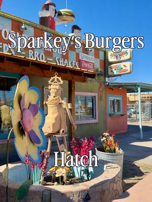 I have wanted to stop at Sparky’s Burgers, Barbecue & Espresso in Hatch, New Mexico for years, and on our recent trip to southern New Mexico, we finally made it happen! Hatch, New Mexico is known as the Chile Capital of the World, and Sparky’s has become a legendary roadside stop for one of the state’s most talked-about green chile cheeseburgers. James and I both ordered the Combo #1, which includes their famous green chile cheeseburger, a side, and a drink. The burger absolutely lived up to its reputation. The pieces of roasted Hatch green chile were huge and piled on generously, and it definitely had some heat to it. James also ordered a vanilla shake that looked really tasty and thick A fun detail I didn’t know about before going was they give you fortune cookies with your meal, and the restaurant walls are covered with fortunes that people have stuck among the fun and eclectic art that covers nearly every surface. The outside of the restaurant is very memorable with giant statues and colorful roadside figures that make it impossible to miss when you drive through Hatch. If you are ever driving through southern New Mexico and love green chile cheeseburgers, Sparky’s in Hatch is definitely a spot worth stopping for! 