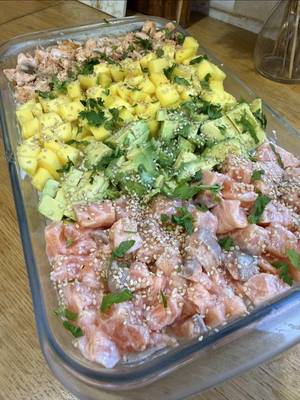 Travessa tipo sushi 🍣 Guarda já e diz-me se vais experimentar!  Ingredientes 1 chávena de arroz carolino 2 chávenas de água 1 colher de chá de sal 3 postas de salmão fresco previamente congelado 1 manga madura 1 abacate Sumo de 1 lima Queijo creme tipo Philadelphia light (~4 c sopa) Sementes de sésamo q.b. Ervas aromáticas frescas a gosto (salsa ou cebolinho) Preparação Coloca o arroz, a água e o sal num tacho e deixa cozinhar até o arroz ficar macio. Reserva e deixa arrefecer ligeiramente. Retira a pele e as espinhas das postas de salmão e corta o salmão em cubos pequenos. Tempera com o sumo de lima e uma pitada de sal. Retira metade do salmão e cozinha-o numa frigideira durante alguns minutos, apenas até ficar cozinhado. Assim também pode ser consumido por crianças pequenas. Corta a manga em cubos pequenos e o abacate também em cubos. Numa travessa, coloca o arroz cozido e espalha bem. Barra uma camada de queijo creme por cima do arroz. Distribui metade do salmão já cozinhado, junta a manga e o abacate e finaliza com o restante salmão marinado. Polvilha com sementes de sésamo e ervas aromáticas frescas picadas antes de servir. Podes servir com molho de soja (opcional).