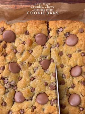Crumbly, chewy chocolate chips cookie bars🤤 Ingredients: •115g cold chopped unsalted butter •80g caster sugar •80g light brown sugar •220g chocolate chunks or chips( you can increase or reduce this according to your preference)  •238g plain flour  •½ tsp salt •1½ tsp baking powder •¼ tsp baking soda •1 egg + egg yolk  •½ tsp vanilla Instructions: •In a large mixing bowl, add the cold cubed butter and whisk until slightly creamy. Add the white sugar and light brown sugar, then whisk together until well combined and fluffy. •Add the egg+egg yolk, vanilla extract, and chocolate chips or chunks. Whisk until fully incorporated. •Add the flour, baking powder, baking soda, and salt. Gently mix until just combined, do not overmix. •Place the cookie dough balls onto a 8*8 Square tray  •Preheat oven to 175C (350°F). Bake for 30-35 minutes or until the tops are lightly golden while the centres remain soft. **If the top turns golden but the inside is still very raw, cover it loosely with foil and continue baking** •Remove from the oven and let cool slightly. •Serve warm with ice cream🤤 #cookie #chocolate #fyp #explorepage✨ #dessert 