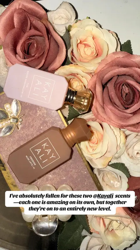 My fave scents Boujee Marshmallow and Freedom Musk latte Kayali perfumes surrounded by soft roses and delicate blooms, highlighting their elegant bottles and the romantic, layered scents they create when worn together. #kayali #kayaliperfumereview #perfumetiktok #fyp 