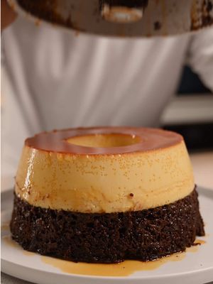 This chocoflan? Absolute insanity. I drizzled it with dulce de leche, and one bite—just one—made me lose all sense of self-control. Chocolate cake? Flan? Caramel? All in one glorious bite. Honestly, might be one of the best desserts I’ve ever made. 🍫🍮💦 Recipe Caramel: 2/3 – 3/4 cup sugar Flan: 6 eggs, 150 g cream cheese (just a little more than half a 250 g block), 1 cup sweetened condensed milk, 1 1/4 cup evaporated milk, 1 tsp vanilla, pinch of salt Chocolate cake: 1 box mix + eggs, oil, milk (according to instructions) Dulce de leche drizzle: 1 can condensed milk, pinch of salt, water to thin Method 	1.	Melt sugar over medium heat until golden. Pour into greased bundt pan; let cool. 	2.	Blend eggs, cream cheese, condensed & evaporated milk, vanilla, and salt. Let sit a few minutes, then strain. 	3.	Make cake batter. (If too thin, it may mix with the custard and prevent clean layers.) 	4.	Pour cake batter into bundt pan over caramel. Gently pour flan mixture over the back of a spoon. Cake will rise as flan settles. (Even if it doesn’t, the flan is heavier than the cake, so it will separate—just not perfectly.) 	5.	Tent with foil, place in hot water bath. Bake ~90 mins, or until knife comes out mostly clean. Remove foil last 5 mins. Cool completely. 	6.	Heat pan of water, dip cooled pan 30–45 sec. Place plate on top, confidently flip, tap bottom, remove pan. 	7.	Boil condensed milk 2.5 hrs, cool, thin with water + pinch of salt. Drizzle over chocoflan. 	8.	Slice, drizzle, and prepare for the most ridiculous bite of your life. #EasyRecipes #chocoflan #caramelflan 