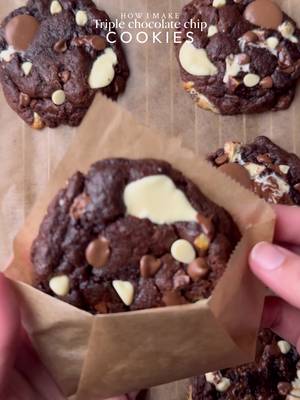 The most indulgent, Triple chocolate chip cookies🤤 Ingredients: •115g cold chopped unsalted butter •80g caster sugar •80g light brown sugar •220g brown & white chocolate chunks or chips •27g cocoa powder  •1/2 tsp instant coffee  •205g plain flour  •½ tsp salt •1½ tsp baking powder •¼ tsp baking soda •1 whole egg + egg yolk  •½ tsp vanilla Instructions: •In a large mixing bowl, add the cold cubed butter and whisk until slightly creamy. Add the white sugar and light brown sugar, then whisk together until well combined and fluffy. •Add the eggs, vanilla extract, cocoa powder, instant coffee and chocolate chips or chunks. Whisk until fully incorporated. •Add the flour, baking powder, baking soda, and salt. Gently mix until just combined, do not overmix. •Portion the dough into 90g balls and roll into a ball. Place the cookie dough balls onto a tray and freeze for at least 30 minutes (or overnight for best results). •Preheat oven to 175-180C (350°F). •Bake for 10-15minutes or until the corners are crispy while the centres remain soft. •Remove from the oven and let cool and set. •Serve warm with vanilla ice cream, enjoy!✨ NOTE: Store any extra dough balls in an airtight container or freezer bag and freeze for later. Whenever a cookie craving hits, bake straight from frozen 🫶🏻 #cookie #chocolate #fyp #whitechocolate #explorepage✨ 