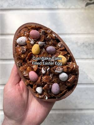 Did someone say Cornflake Cake… IN an Easter egg?! 🍫 Easter eggs have far too much empty space. So @Cahill fixed that the only way he knows how. First, pack the shell with moist chocolate cake crumbs, then drown it in a silky milk chocolate ganache, topped with a crunchy chocolate cornflake cake loaded with smashed Mini Eggs and even more chocolate. Leftover Easter chocolate? Sorted. Save this one for Easter weekend! #cake #easterchocolate #egg #dessert #eastereggs 