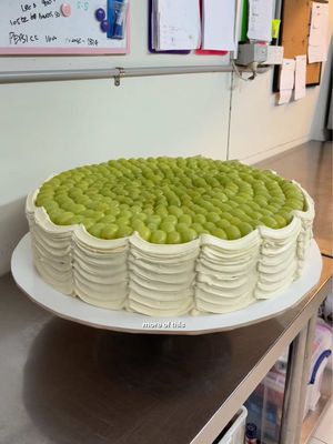 Wedding Cake🍇✨ This was never meant to be eaten and that was entirely the point. A 20 inch fake grape cake built from foam, real buttercream and an entire bunch of green grapes, made purely for the cutting moment. carved out a real section inside so the cut was genuine, piped buttercream curtains down the sides and covered the top in grapes until she looked exactly how i imagined her! #weddingcake #wedding #cake #cakedesign #fypシ゚ 