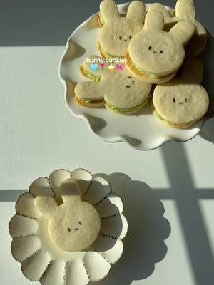 Miffy bunny sugar cookies with matcha buttercream fillings & sprinkles  Cookie recipe: - 2 and 1/4 cups all-purpose flour, plus more as needed for rolling and work surface - 1/2 teaspoon baking powder - 1/4 teaspoon salt - 3/4 cup unsalted butter, softened to room temperature - 3/4 cup sugar - 1 large egg, at room temperature - 2 teaspoons pure vanilla extract - 1/4 teaspoon almond extract Steps: 1. In a bowl combine flour, baking powder and salt  2. In a separate bowl, cream together butter and sugar until light colored (about 3-4 min on high speed) 3. Add egg, vanilla, and almond extract. Whisk until everything is combined  4. Mix in dry ingredients  5. Place dough on floured parchment paper and roll until it reaches 1/4 in thickness. Cover and let dough chill in fridge for 1-2 hrs 6. Remove dough from fridge and use cookie cutter to cut out desired shapes.  7. Bake in preheated oven at 350F for 12 minutes.  Matcha buttercream recipe - 8 tablespoons unsalted butter (softened at room temperature) - 1 1/4 cups powdered sugar - 2 teaspoons matcha powder - 2 teaspoons vanilla extract Steps: 1. In a mixing bowl, whisk the butter until light and creamy 2. Add sugar and continue whisking until combined 3. Sift in matcha powder and add vanilla extract. Beat until smooth #homebaking #whimsicalfood #cookies 
