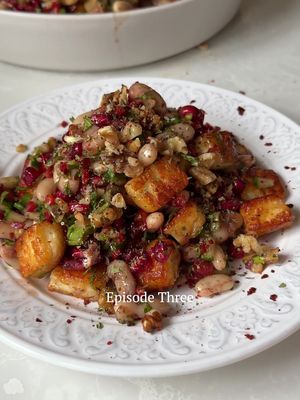 My Favourite Things: EP. 3 CANNELINI BEAN, CRISPY HELLİM & CRUNCHY WALNUT SALAD Serves 4-6 Prep: 10 minutes Cook: 5 minutes 225g (8oz) hellim (halloumi), cut into 1cm cubes 3 tbsp extra virgin olive oil 1 x 400g (14oz) can cooked cannellini beans, washed and drained 25g (1oz) fresh coriander, leaves and stalks finely chopped 200g (7oz) pomegranate seeds 2 small Middle Eastern cucumbers or 1/3 English cucumber (de-seeded), finely diced 1 large red romano/capia pepper (kapya biber)/small red bell pepper, finely diced 2 spring onions, thinly sliced 1 tsp sea salt flakes 3 tsp dried mint 2 tsp sumac 2 tsp pul biber 100g (3½oz) shelled walnuts, roughly chopped 2 tbsp pomegranate molasses #melizcooks #salad #choppedsalad #finelychopped