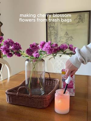 The perfect decoration during cherry blossom season! 🌸🩷 - Unfold trash bag and keep it flat - Cut roughly 5”x5” squares from the bag (keep both layers) - Fold square over 3 times, accordion style - Round the ends by trimming - Tie at the center - Fan out each side and fluff - Tie onto branches and style how you like!