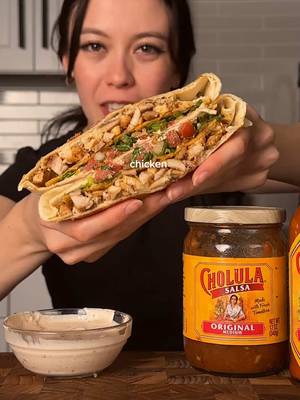 crispy Cholula chicken crunchy wrap @Cholula Hot Sauce #cholula #crunchywrap #cremosa #cholularecipes #CholulaPartner  chicken marinade (4 portions): 4-6 boneless skinless chicken thighs 1 package Cholula® Original Taco - Medium Recipe Mix 2 tbsp olive oil *mix everything together and marinate in the fridge for at least 30 min. grill until cooked through then chop into smaller pieces. Cholula crema 1/2 cup (120g) sour cream 1/4 cup Cholula® Original - Medium Salsa 1 lime, juiced pinch of salt *mix all together and set in the fridge until ready. assembly: 4 large flour tortillas (~12 inch) 4 small flour tortillas (~6 inch) shredded cheese 4 small tostadas shredded lettuce diced & seeded roma tomatoes pickled jalapenos chopped cilantro Cholula® Original Hot Sauce *lay out one of the large flour tortillas, spread on the Cholula crema in a circle in the middle. then top in this order -> cheese, chicken, tostada, lettuce, cilantro, tomato, jalapenos. then grab a small tortilla and spread on some more Cholula crema. place it crema-side down and fold the sides of the big tortilla over the smaller one. place is seam-side down on a pan (optional: add butter to help toast it) and cook until nice and golden brown on med heat. to serve, top with cilantro plus some Cholula hot sauce 🙂