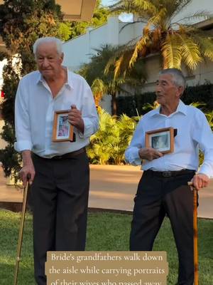 Bride's grandfathers walk down the aisle while carrying portraits of their wives who passed away.