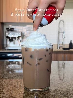 Stop spending $5–$7+ at Dutch Bros…you can make ALL of these at home 👀 Here are 5 Dutch Bros drinks using simple grocery store ingredients, no fancy machines or equipment needed. Golden Eagle (Caramel Vanilla Breve) ½–1 oz vanilla syrup ½–1 oz caramel sauce (+ extra drizzle) 2 shots espresso 6 oz half & half Ice 👉 Stir everything together + finish with caramel drizzle 💡 No machine? Use 2 tsp instant espresso + 2 oz water to get your 2 shots Golden Eagle Chai ½–1 oz vanilla syrup ½–1 oz caramel sauce (+ extra drizzle) 4 oz chai concentrate 4 oz half & half Ice 👉 Combine, stir + top with caramel drizzle Protein Mocha 2 shots espresso 6–8 oz chocolate protein milk Ice Optional: whipped cream 👉 Combine, mix + pour over ice 💡 No machine? Use 2 tsp instant espresso + 2 oz water to get your 2 shots Peach Green Tea 12 oz green tea 1–2 oz peach syrup Ice 👉 Combine, mix + pour over ice 💡 Swap the syrup flavor or tea type to customize! Lavender White Chocolate Freeze ½–1 oz lavender syrup ½–1 oz white chocolate sauce 2 tsp instant espresso 6 oz half & half ¾ cup ice ⅛ tsp xanthan gum 👉 Blend until smooth You don’t need:�❌ espresso machine�❌ barista skills�❌ fancy ingredients Just simple grocery store swaps + a few easy tricks ☕️ Save this for your next coffee run at home & follow for more easy at-home coffee recipes! #dutchbros #dutchbroscoffee #coffeeathome #easycoffee #coffeeforbeginners