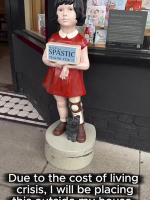 Thinking of putting one of these outside my house. Cost-of-living crisis and all that. Everyone’s got a side hustle these days. What’s yours… #BritishComedy #DisabilityComedy #AccessibilityMatters #CostOfLiving Video description: A vintage charity collection statue of a young girl in a red dress holding a box that reads “Help the spastic thank you,” standing outside a shop window. A caption over the video reads: “Due to the cost of living crisis, I will be placing this outside my house. All donations welcome!”