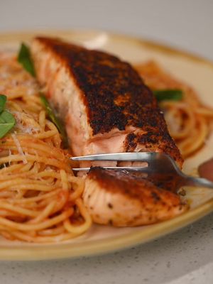 Salmon Tomato Spaghettini You: Salmon tonight? Me: Say less  Pan roasted Salmon, Cherry tomato sauce, Spaghettini  Ingredients: * 3 salmon fillets * Salt * Black pepper * Cajun seasoning * 2 pints cherry tomatoes * 2 cloves garlic (crushed) * 1 tsp chili flakes * 1 tsp salt * ½ pack spaghettini * Basil * Parmigiano-Reggiano * Olive oil Method: 1. Season salmon with salt, black pepper, and Cajun seasoning. Heat oil in a pan over medium-high heat. Sear on both sides until deeply golden and cooked to your liking. Remove from the pan and let rest. 2. In the same pan, reduce heat to medium. Add cherry tomatoes and sauté until blistered. Add garlic and chili flakes. Use a masher or a fork to lightly crush the tomatoes into a sauce. 3. Add 1 tsp salt and black pepper. Let simmer until slightly thickened. 4. Cook spaghettini until al dente. Add directly into the sauce and toss. 5. Add basil and Parmigiano-Reggiano. Toss until glossy and emulsified. Taste and adjust seasoning. 6. Plate the spaghettini. Top with salmon. Finish with basil and Parmigiano-Reggiano. #EasyRecipes #salmonpasta #spaghetti 