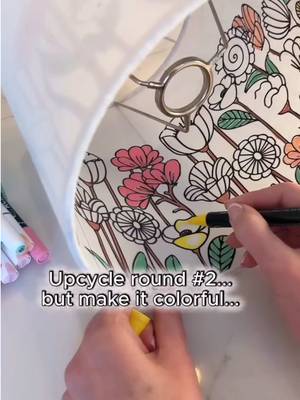 Colored lampshade upcycle - My first upcycled lampshade using decals on the inside completely went viral and so many of you kept saying… “Okay but what if you tried one with color?” So challenge accepted… 🤗 This time I went full floral with it and thought these whimsical flowers were just asking for a little color. Instead of pulling out messy paint and it dripping everywhere I grabbed my acrylic paint markers and they ended up being absolutely perfect for filling in between all of the black decal outlines. It was simple, relaxing, and so fun watching it all come to life. And I have to admit… adding color gave this lampshade such a different look and feel from my first black-and-white version. Same idea, completely different vibe, and I’m kind of loving both for totally different reasons👍🏻 #DIY #lamp #decor #lights #fyp