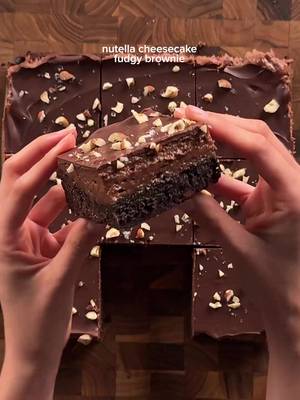 nutella cheesecake fudgy brownies brownie: 3/4 cup (170g) unsalted butter 1 1/2 cups (300g) sugar 3 eggs 3/4 cup (63g) cocoa powder 3/4 tsp (4g) salt  3/4 tsp (3g) baking powder 2 tsp (8g) vanilla 1 cup + 2 tbsp (140g) ap flour 1/2 cup chocolate chips *mix together eggs, cocoa powder, salt, baking powder, and vanilla. in a separate bowl add and mix the butter and sugar, then microwave gradually until sugar dissolves and is shiny. combine the egg and butter mixtures well, then add flour and mix gently, do not over mix because it turns cakey. pour into 9x9 pan and bake at 350 for 26-30 min. let cool completely. nutella cheesecake: 8 oz (226g) cream cheese, soft 1/4 cup (60g) mascarpone 3/4 cup (200g) nutella 1/2 cup (60g) powdered sugar 1-2 tsp lemon juice 1 tsp (4g) vanilla pinch of salt *cream the cream cheese and mascarpone together until its smooth. then add in the nutella (melt a bit so its easier to mix), powdered sugar, vanilla, and salt. spread over the cooled brownie and set in the fridge at least an hour.  topping: 200g semisweet chocolate chopped hazelnuts *melt chocolate and pour over the cooled and set cheesecake layer. add on chopped hazelnuts and set in the fridge until top is solid. #cheesecake #brownies #nutella #Recipe 