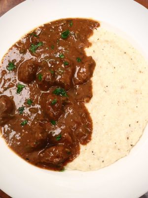 Louisiana grits and grillades is a staple in many Louisiana homes. This dish is a Louisiana Creole specialty that dates back to the 19th century. Served over creamy grits, it's become one of New Orleans' most beloved comfort foods and proof that shrimp isn't the only thing that belongs on grits. Have you ever heard of this dish, and if not, would you give this a try? This recipe can be found on my website in my bio. #risascuisine #grillades #neworleans