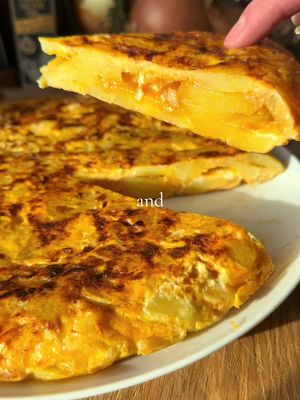 Traditional Spanish Omelette (Tortilla de patatas) 🍳 Here’s a traditional Spanish Omelette for you. The Spanish Omelette is a delicious but often misrepresented dish. In this traditional recipe, we only use 3 ingredients (eggs, onions, and potatoes), and we fry the onions and potatoes in a generous amount of Olive Oil. Full recipe below ⬇️ Serves 4. Ingredients - 500 g waxy potatoes (e.g. Desiree), peeled and sliced 4–5 mm thick - 1 large onion, thinly sliced - 7 large eggs - 750 ml Extra Virgin Olive Oil (for frying) - Salt and freshly ground black pepper Method 1. In a large nonstick pan, heat Extra Virgin Olive Oil over medium-high heat. Fry the onion first for around 5 minutes. Then add in the potato slices and cook for another 10 - 15 minutes until tender. The onion should be lightly caramelised. Remove with a slotted spoon into a bowl, reserving most of the oil. 2. In a separate bowl, whisk the eggs with salt and pepper. Gently fold in the potatoes and onions; let rest for 30 minutes. 3. Wipe out the pan and return 3–4 tablespoons of the reserved oil over medium-low heat. Pour in the egg mixture, spreading it evenly. Cook until the edges set (about 7–8 minutes). 4. Cover the pan with a large plate and, using oven mitts, quickly flip the omelette onto the plate. Slide it back into the pan (uncooked side down) and cook for another 5 minutes until set but still soft in the middle. 5. Let rest a few minutes before slicing. Enjoy warm or at room temperature! #cooking #spanish #Recipe #eggs #tortilla