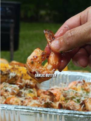 Lemon Garlic Butter Shrimp on the Pellet Grill Recipe: -Prep the shrimp with olive oil, cajun seasoning, and red pepper flakes. -In a skillet add 2 sticks butter, 4 cloves garlic minced, red pepper flakes, zest from 1 lemon, cajun seasoning, green onions, and parsley. -Put the shrimp on skewers then place on grill at 400F for 14 minutes, flipping halfway, and add 2 more sticks of butter to melt into the sauce. -Slide the shrimp off the skewers onto a bed of corn, pour the butter sauce all over, then top with parmesan cheese and parsley then enjoy!