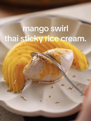 Mango Swirled Thai Sticky Rice Cream.  🥥 Black glutinous rice coconut base 🥭 Tart mango sorbet Made this flavour for the first time last year, and after many more batches, this iteration is definitely the best—thanks for the mango sorbet suggestions! Want to see a specific flavour? Leave me a comment ✨ Find the recipe for this on my Substack.