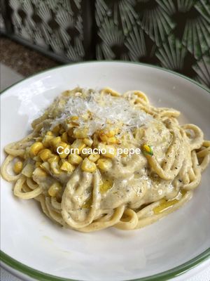 Jokes aside, Italy, I love your food sm it just gives me cramps ✨🫶 This buttery, toasty, creamy corn cacio e pepe is for my pasta loving friends who want a little less cheese but just as much indulgence. It's so easy to whip up and makes a gorgeous summer dinner. It is wholly untraditional but sometimes as vegans we have to work a little harder to make magic. Yes it takes a few more ingredients but it is absolutely worth it. RECIPE for 2-3  75g cashews, soaked for 20 minutes in boiling water 25g vegan butter 1 small onion, finely chopped 2 cloves garlic, finely sliced 200g corn (preferably off the cob) 1 tbsp white miso paste 10g nutritional yeast 100ml soy milk 1 tbsp vegan butter ½ tbsp olive oil ¾ -1 tsp coarsely ground black pepper 200g pasta of choice 1. Heat a large pan over medium heat. Melt the vegan butter then add the diced onion and fry with a pinch of salt until translucent. 2. Add the corn and fry for around 5-6 minutes with the onions until softened. 3. Add in the garlic and fry for a further minute or so. Place the pasta onto a boil with plenty of salt. 4. Tip the cashews and corn mixture into a blender with the miso, nutritional yeast and soy milk. Blend until completely smooth then season to taste (don't add too much salt as you'll be adding salty pasta water to the sauce later). 5. Fry the vegan butter and olive oil in a frying pan over a medium low heat. Add the black pepper and fry until sizzling and aromatic. 6. Add the pasta sauce to the pan with plenty of pasta water and stir to emulsify. Drop in the cooked pasta and stir it all together until creamy and saucy (more pasta water helps form a loose sauce that clings to the pasta). 7. Serve with more nutritional yeast or vegan parmesan and enjoy!