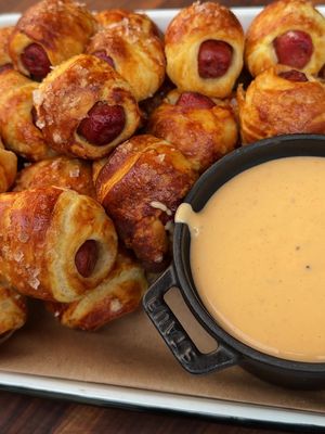 Pigs in a blanket walked so pigs in a pretzel could run. 🔥 Wrapped in soft pretzel dough and served with beer cheese, these are the kind of snacks that disappear before they make it to the table. Summer parties, game days, backyard hangs—this one's built for all of them. #Traeger #TraegerGrills #TraegerRecipes #Traegerhood #PigsInAPretzel #BeerCheese #BBQ #Grilling #BackyardBBQ #GameDayFood #PartyFood #WoodFiredFlavor Recipe in caption