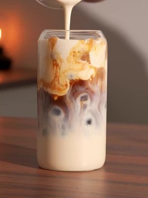 Healthier Cheesecake Iced Latte 🤎 Recipe 👇🏽 I used German Butter Cookies for the milk base. For those who don’t know em think Lotus Biscoff cookies, but less spiced and a bit more buttery. Crisp, lightly sweet, and perfect with coffee or tea :D Recipe: - soak a cookies of choice (some cereal works as well) in 150-180 ml/ 5-6 oz of your milk of choice (10 min) - while soaking the cookies make date caramel * pour 120 ml boiling water over 7-9 dates (depending on size) * soak for 5 min (you can brew the needed double shot of espresso while waiting) * blend until smooth  - use date caramel for your cold foam: * 3 tsp Greek yogurt  * 2 tsp date caramel  * vanilla bean paste  * pinch if salt  * froth till creamy - add ice to serving cup  - pour in your cookies milk over ice - slowly add a double espresso to create a layering effect - re-foam your cold foam if necessary and layer it on top  - optionally garnish with a cookie :) That’s it. Enjoy! 😁 #icedcoffee #icedlatte #coffeerecipe #homebarista 