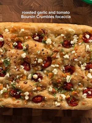 roasted garlic and tomato Boursin Crumbles focaccia @boursin #BoursinCrumblesSummer  dough:  2 cups (256g) bread flour 2 cups (256g) ap flour 2 tsp (10g) kosher salt 1 pkg3 instant yeast 2 cups (455g) lukewarm water 5-6 tbsp olive oil + more for greasing flaky salt *whisk together the flours, salt, and instant yeast. add the warm water and mix until there are no flour streaks. should look wet and shaggy. cover and let rest 15 min at room temp, then fold the dough over it's self 4-6 times. this is done by grabbing one side of the dough and stretch and fold it over to the other side. rotate 90 degrees and fold again etc. then rest again for another 15 min. repeat this process for an hour. after the folds, cover with plastic wrap and let rise at room temp for 1.5-2 hours, or until doubled in size. note: its warm in Austin so i covered and put mine outside and it took about 1hr to rise! grease a 9x13 pan with olive oil and gently press the dough to the sides of the pan. cover loosely and let rest about an hour. it should be puffy and jiggly! then drizzle 2-3tbsp olive oil on the top and gently dimple the dough. add the toppings. bake at 425 for 25-30 min until its golden. add more Boursin Crumbles on top right out of the oven. let rest a few min before slicing :) toppings: 1 pkg of Boursin Crumbles Garlic & Fine Herbs 2 whole heads garlic 2 cups cherry tomatoes 4 tbsp olive oil salt and pepper fresh basil (for after) *slice the tops off the garlics and drizzle generously with olive oil and salt. wrap in tin foil and set on a small baking tray. season the cherry tomatoes (whole) with olive oil, salt, and pepper add to another small baking tray. set both trays into the oven at 400. take the tomatoes out when they look a bit blistered and a lil caramelized. take the garlic tray out after about 30-40 min when its golden. let both of these cool completely. #garlic #tomato #focaccia 