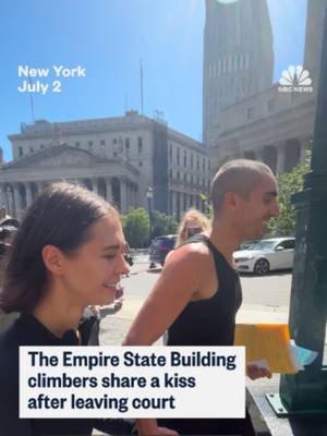 The Empire State Building climbers share a kiss after leaving court where they pleaded not guilty to a slew of a criminal charges.