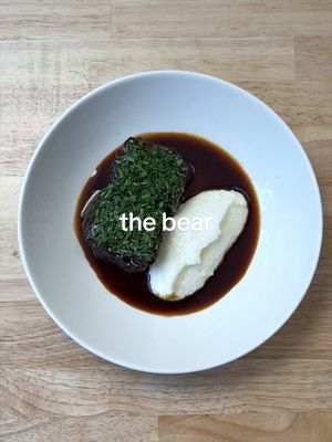 How to Make Coca Cola-Braised Short Ribs (from the Bear) 🐻  FULL RECIPE BELOW ⬇️  (feeds 4 people as a small main course)  INGREDIENTS: 800g boneless beef short ribs 355mL bottle Coca Cola 1L beef stock 1 onion 1 large carrot 1 tbsp tomato paste 2-3 tbsp fish sauce 2 tbsp neutral oil 1/2 bunch parsley 3-4 sprigs thyme 1/2 cup white polenta 1 cup milk  1 cup water 50g fresh Parmesan (to grate) 2 tbsp cold butter  Fine sea/kosher salt (to taste) INSTRUCTIONS: 1. Ideally 24 hours before cooking, cut your short ribs into 4 equal portions, and dry them out on a wire rack in the fridge overnight.  2. Pre-heat your oven to 325 degrees Fahrenheit. Season your short ribs generously with salt. Peel and cut your onion & carrot into large chunks. In a large Dutch oven, sear your short ribs over medium-high heat in 2 tbsp neutral oil until nicely browned.  3. Remove the short ribs, turn the heat down to medium, and add your carrots & onion. Sauté for 3-5 minutes, or until lightly caramelized. Add your tomato paste and sauté for 1 more minute. Add your Coca Cola to deglaze, and add back in your short ribs. Cover everything with beef stock, and bring to a boil. Once at a gentle simmer, add your fish sauce, thyme, and the stems from your parsley. Cover your pot, and transfer it to the oven. Cook for 2-3 hours, or until the short ribs are fork tender. When finished, let the short ribs rest in the liquid to cool to room temperature.  4. For your polenta, bring your milk & water to a boil in a medium pot. Bit by bit, whisk in your polenta. Cook your polenta, stirring often, for 30 minutes. When it has thickened to the point it can stand up on a plate. Add your cold butter, grated Parmesan, and a pinch of salt to taste. Whisk to combine, and keep warm.  5. Remove the short ribs from the pot and place them in a container for the moment. Strain out all the other solids in the braising liquid, and reduce the braising liquid over medium heat until it has slightly thickened. This will be the glaze for your short ribs. Add your short ribs back into the pan, and warm them through in the glaze. 6. Roughly chop your parsley leaves. Serve your short ribs, garnished with parsley, along with a dollop of polenta. With whatever glaze is left in the pan, thin it out with a little bit of water to get a looser, saucier consistency. Finish each plate with a drizzle of sauce. Enjoy! #thebear #cocacola #shortribs #homecooking #recipe 