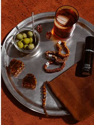 Say buonasera to The Aperitivo Collection: a limited-edition ritual inspired by the slow drift from sun-soaked afternoons into evening aperitivo. Everything you need for your best summer air dry, thoughtfully curated in one pouch. Meet your ritual: ⁓  The Clips in Honeyed Amber Handcrafted in France to set, style, and effortlessly refresh your summer air dry. ⁓  The Scrunchie No. 001: Golden Hour Three 100% silk scrunchies in sunset-inspired shades that protect hair without creases. ⁓  The Travel Pouch in Striped Spritz A striped canvas pouch with a custom beaded pull to keep your ritual close at hand. ⁓  Travel Texturizing Air Dry Mousse A crunch-free foam that enhances natural texture with soft volume and flexible hold. Your best summer hair, available 7.7 exclusively at crownaffair.com.