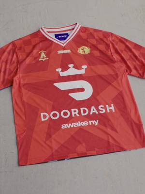 Streetwear meets the global game with the @AWAKE NY x @DoorDash capsule that highlights how food and community bring us all together. Watch as we unbox the standout star graphic soccer jersey, the mesh camo shorts, the heavyweight black quarter-zip, and the matching mini soccer ball. #doordashpartner