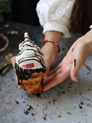 Instead of a waffle or cake cone, try a flaky, warm croissant as an ice cream cone! The buttery crisp texture of the croissant is absolutely perfect with this creamy raspberry ice cream and chocolate drizzle.