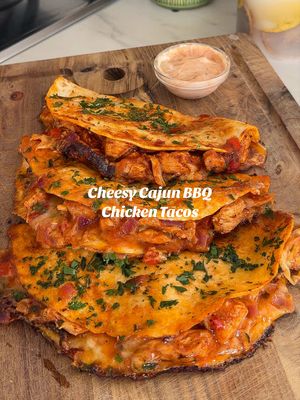 Ad CHEESIEST CAJUN BBQ CHICKEN TACOS 🌮🧀 The ultimate cheesy chicken tacos using @Cathedral City  Serves 2 Ingredients For the chicken 	⁃	300g chicken breasts strips  	⁃	1 diced red pepper 	⁃	1 diced red onion 	⁃	200g passata 	⁃	40g BBQ sauce 	⁃	100ml chicken stock 	⁃	Splash of Worcestershire sauce 	⁃	1 tbsp BBQ seasoning, Cajun seasoning & chicken seasoning   To serve 	⁃	6 mini tortillas 	⁃	100–120g Cathedral City Mature Cheddar, grated 	⁃	Fresh parsley  	⁃	Cajun mayo  Method Season the chicken breasts strips with the BBQ seasoning, Cajun seasoning & chicken seasoning. Heat a large frying pan over a medium-high heat with a few sprays of oil. Sear the chicken for 3–4 minutes on each side until nicely browned. In the same pan, add the sliced onion and red pepper for 5–6 minutes until softened.  Pour in the passata, BBQ sauce and chicken stock, stirring well. Bring to a gentle simmer cover with a lid for 8-10 minutes, or until the chicken is fully cooked. Remove the chicken, shred with two forks, then stir it back into the sauce with the peppers and onions.  Give each tortilla a quick dip in the chicken sauce (don't soak them), place the tortilla onto the hot griddle pan or baking tray, then fill with a generous handful of Cathedral City cheddar, the chicken mixture, another sprinkle of cheese. Then fold them over.  Lightly spray the tops with oil and bake for 8–10 minutes, until the tacos are crispy and the cheese is perfectly melted. (Optional) Finish with some garlic butter  Serve immediately and enjoy   #cheesychickentacos #EasyRecipes #chickentacos  #cathedralcity #cathedralcitycheese 