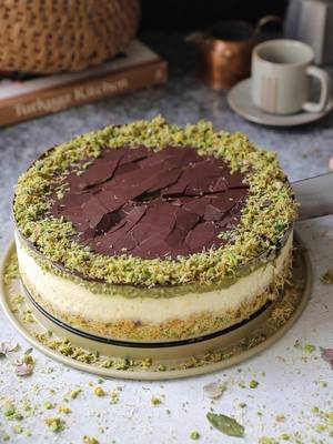 Do you still enjoy the flavors of Dubai chocolate? I know I do ☺️
 
 You can also find the recipe on my website.
 
 Dubai Chocolate Cheesecake
 
 Ingredients:
 For the Crust:
 2 cups kataifi
 5 tbsp butter, separated
 1/3 cup granulated sugar
 1/2 cup crushed raw Turkish pistachios
 Pinch of salt 
 
 For the Cheesecake Batter: 
 3 8 oz (678g) packages cream cheese 
 1/3 cup (80g) sour cream
 3/4 cup (180g) heavy cream
 1 cup (200g) granulated sugar
 2 tbsp (17g) all-purpose flour
 1/2 tbsp (5g) corn starch
 1 tsp (5g) vanilla
 3 large (155g) eggs 
 
 For the Dubai Chocolate Layer: 
 1 1/2 cups kataifi 
 1 tbsp peanut oil (optional) 
 1 heaping cup (320g) pistachio cream 
 1/4 cup crushed pistachios (optional) 
 125g high quality chocolate (66% cocoa or to your preference)
 
 Instructions:
 Prepare the Crust: Using a sharp knife, cut the kataifi into small pieces as in the IG reel. Add into a medium pan over low heat, toast the kataifi slowly, stirring occasionally. When the color becomes a lightly gold, add 1 tbsp butter and continue to toast until crisp and golden brown. Remove from the heat and let cool.
 
 In a medium bowl, add toasted kataifi, granulated sugar, pistachios, and remaining melted butter and mix well.
 
 In a 9-inch springform pan, add the kataifi mixture and use the bottom of a glass to press it well along the bottom of the pan. Place in the refrigerator until ready to use.
 
 Preheat the oven to 320F.
 
 Prepare the Cheesecake Batter: In another medium bowl, add cream cheese, sour cream, heavy cream, and granulated sugar. Using an electric mixture, whisk until perfectly smooth and creamy. Add flour, corn starch, and vanilla. Continue to mix until combined well. Whisk in the eggs one at a time, mixing fully between each.
 
 Remove the pan from the fridge and pour the cheesecake mixture over the crust. Spread evenly and then tap a few times on the countertop to ensure there are no bubbles in the mixture. Cover the sides and bottom of the pan with aluminum foil.
 
 Fill a larger pan with warm water, so that when you set the springform pan into it, the water rises to 1 1/2” around the sides of the springform. Bake the cheesecake for 70-75 minutes. Remove from the oven and place on a cooling rack. Let it cool to almost room temperature, then place in the fridge for at least 10-12 hours for the ideal texture.
 
 The next day, prepare the Dubai Chocolate Layer: Repeating the kataifi chopping and toasting process as described for the crust. Once the kataifi is cool, add into a medium bowl with the pistachio cream and crushed pistachios. Mix together until fully combined.
 
 Place the kataifi filling evenly over top of the cooled cheesecake.
 
 Melt the chocolate over a double boiler. At this step, you can add 1-3 tbsp of cream to your chocolate or 1 tbsp butter during this process for a slightly softer chocolate, which will make it easier to cut but won’t give you that hard-crack chocolate top.
 
 Pour the chocolate over the kataifi and then you can decorate the top with some of the kataifi mixture if you want. Place in the fridge until set, about 10 to 15 minutes. Cut in slices and serve with coffee.
 
 Bon appetit!