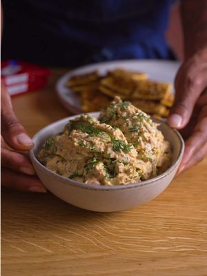 #ad Smoked Fish Dip made with @King Oscar Seafood USA Kipper Snacks. They're packed with protein, rich in Omega-3s, and naturally smoked over oak wood for fire flavor. Creamy, tangy, and loaded with fresh dill, this is the perfect dip to bring to your next summer gathering. Full recipe below. #TinnedFish Smoked Fish Dip Ingredients 3 (3.45 oz) cans King Oscar Kipper Snacks (smoked herring), drained 1/2 cup sour cream 1/3 cup mayonnaise Zest and juice of 1 lemon 2 teaspoons whole grain mustard 1/2 teaspoon Sichuan chili flakes Hot sauce, to taste 2 tablespoons fresh dill, finely chopped Salt and black pepper, to taste For Garnish Fresh chives, chopped Fresh dill Sweet & Spicy Seasoned Crackers Ingredients 1/2 stick salted butter, melted 1 tablespoon brown sugar 1 teaspoon garlic powder 1 teaspoon paprika 1/4 teaspoon cayenne pepper 1 tablespoon sesame seeds 2 sleeves saltine crackers Directions Preheat the oven to 325°F. In a small bowl, combine the brown sugar, garlic powder, paprika, cayenne pepper, and sesame seeds. Arrange the saltine crackers in a single layer on a sheet pan. Brush each cracker lightly with the melted butter. Sprinkle the seasoning mixture evenly over the crackers. Bake for 5–7 minutes, or until lightly toasted and fragrant. In a large bowl, combine the sour cream, mayonnaise, lemon zest, lemon juice, whole grain mustard, hot sauce, Sichuan chili flakes, and fresh dill. Mix until smooth and well combined. Add the drained smoked herring to a separate bowl and use a fork to gently flake it into small pieces. Fold the smoked herring into the mayo/ sour cream mixture until evenly combined. Season with salt and black pepper to taste. Cover and refrigerate for 30 minutes to 1 hour to allow the flavors to meld. Transfer to a serving bowl and garnish with fresh chives and dill. Serve with Sweet & Spicy Seasoned Crackers.