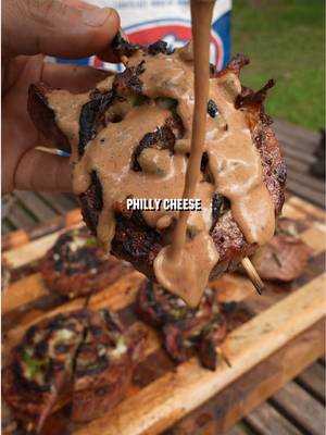 Philly Cheese Flank Steak Pinwheels Recipe: -Start by butterflying a flank steak and opening it up flat.  -Top it with provolone cheese, green peppers, and onions. Season it with salt, pepper, and garlic.  -Roll it up tightly, skewer it, and slice between the skewers.  -Season on the outside and grill over direct heat on both sides until steak hits desired doneness.  #steak #cheesesteak #phillycheesesteak #flanksteak #grilledsteak
