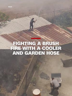 As a 2-acre brush fire approached an auto shop in San Francisco, workers attempted to slow the fire with bottled water and a garden hose until firefighters arrived. The blaze is now under control and an investigation has been launched into whether it was caused by fireworks.