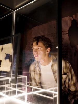The Odyssey cast comes face to face with the oldest known book copy of Homer's epic in existence. Get tickets now to experience Christopher Nolan's #TheOdyssey in theaters everywhere. #TomHolland #LupitaNyongo #HimeshPatel 
